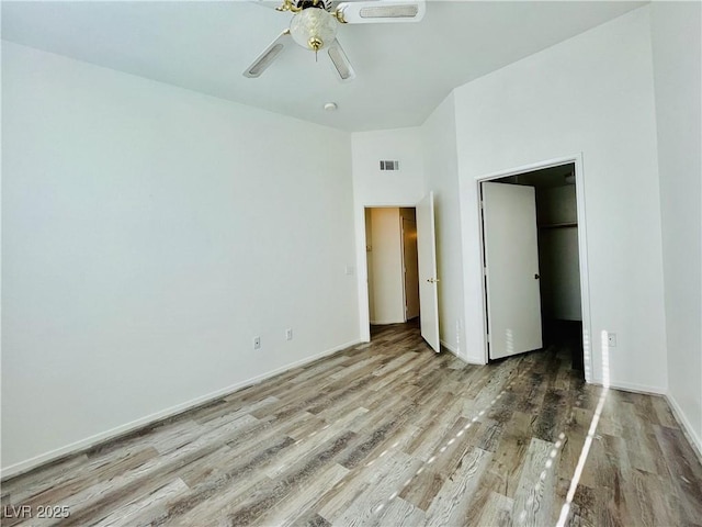 1881 W Alexander Rd Unit 2117, North Las Vegas, NV 89032 - unfurnished bedroom with wood finished floors, a spacious closet, a ceiling fan, and a closet