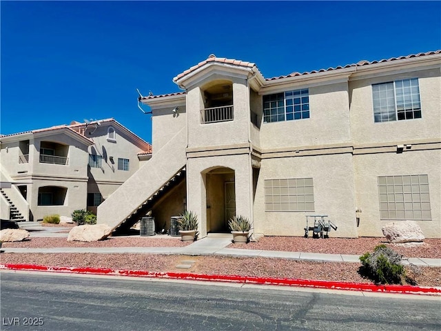 1881 W Alexander Rd Unit 2117, North Las Vegas, NV 89032 - view of front of home featuring stairway, a tile roof, and stucco siding
