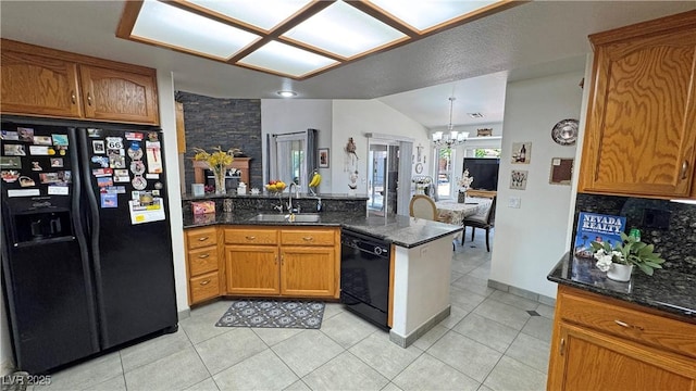 4910 Marywood Ct, Pahrump, NV 89061 - kitchen with black appliances, a peninsula, a chandelier, brown cabinets, and lofted ceiling