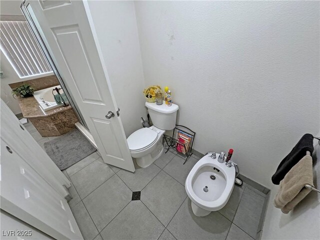 4910 Marywood Ct, Pahrump, NV 89061 - bathroom with tile patterned floors and a bidet