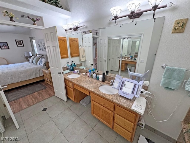 4910 Marywood Ct, Pahrump, NV 89061 - ensuite bathroom with double vanity, tile patterned floors, and a chandelier