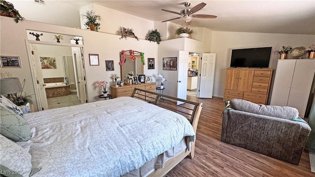 4910 Marywood Ct, Pahrump, NV 89061 - bedroom with vaulted ceiling, wood finished floors, and ensuite bathroom