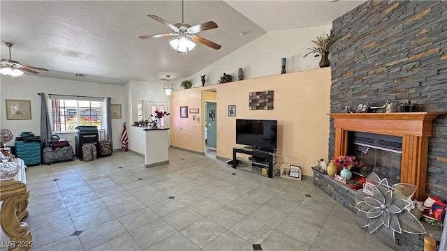 4910 Marywood Ct, Pahrump, NV 89061 - living room with a ceiling fan, vaulted ceiling, a fireplace, and light tile patterned floors