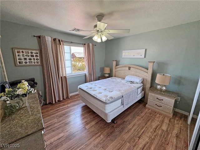 4910 Marywood Ct, Pahrump, NV 89061 - bedroom with wood finished floors, a textured ceiling, and ceiling fan