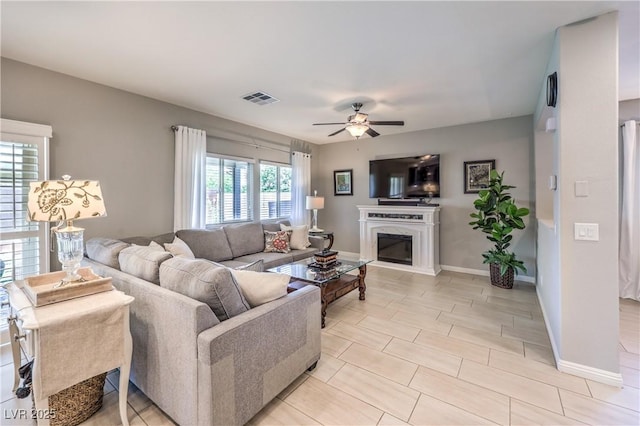 9113 Sea Mink Ave, Las Vegas, NV 89149 - living area featuring ceiling fan and a glass covered fireplace