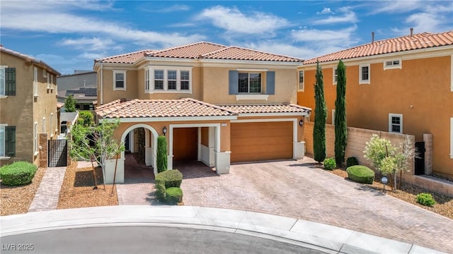 2154 Tortona St, Henderson, NV 89044 - mediterranean / spanish home with stucco siding, a tile roof, decorative driveway, and a garage