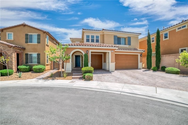 2154 Tortona St, Henderson, NV 89044 - mediterranean / spanish-style home with stucco siding, a garage, decorative driveway, and a tiled roof