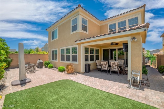 2154 Tortona St, Henderson, NV 89044 - back of house with a tile roof, stucco siding, a patio, and outdoor dining area