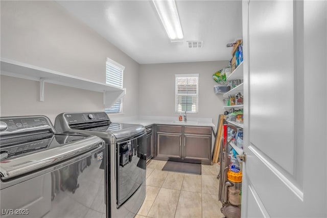 2154 Tortona St, Henderson, NV 89044 - laundry room featuring washer and dryer, cabinet space, and light tile patterned flooring
