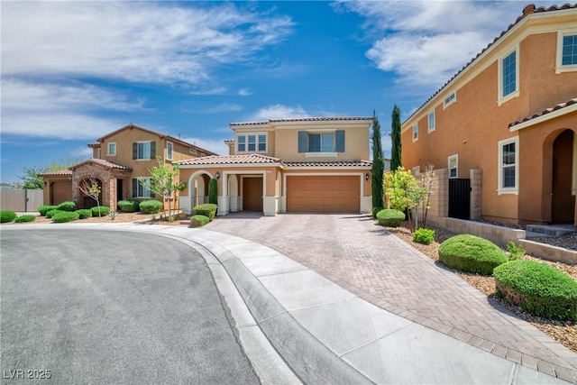 2154 Tortona St, Henderson, NV 89044 - mediterranean / spanish-style home with stucco siding, a tile roof, an attached garage, and decorative driveway