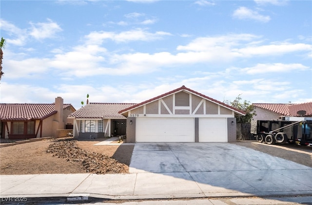 5570 Palm St, Las Vegas, NV 89120 - view of front of house featuring concrete driveway, an attached garage, stucco siding, and brick siding