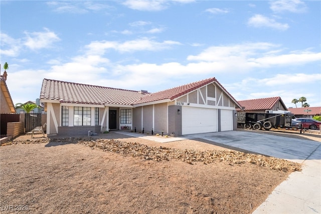 5570 Palm St, Las Vegas, NV 89120 - view of front of property with an attached garage, driveway, stucco siding, and a tiled roof