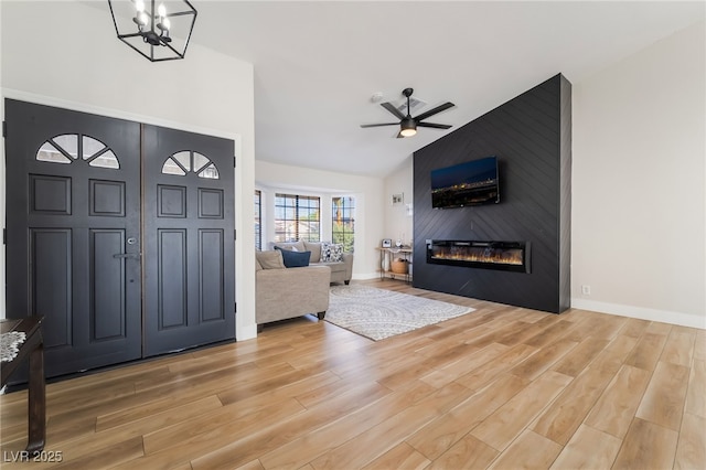 5570 Palm St, Las Vegas, NV 89120 - entrance foyer with light wood finished floors, ceiling fan, a fireplace, and lofted ceiling
