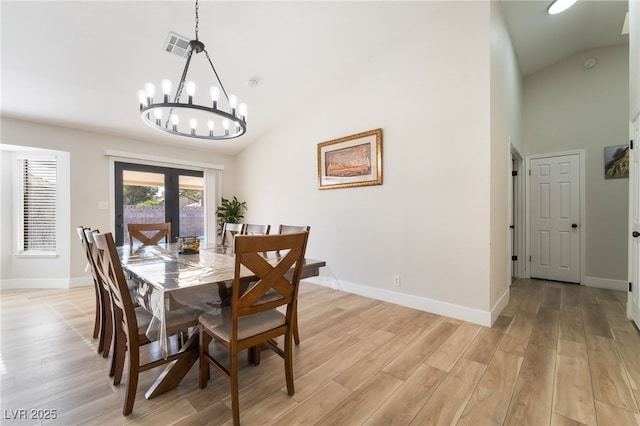 5570 Palm St, Las Vegas, NV 89120 - dining room with high vaulted ceiling, a chandelier, light wood-style flooring, and french doors