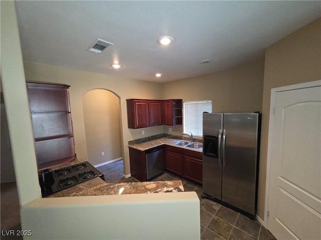 9000 Las Vegas Blvd Unit 2101, Las Vegas, NV 89123 - kitchen featuring appliances with stainless steel finishes, arched walkways, dark tile patterned floors, dark brown cabinets, and recessed lighting