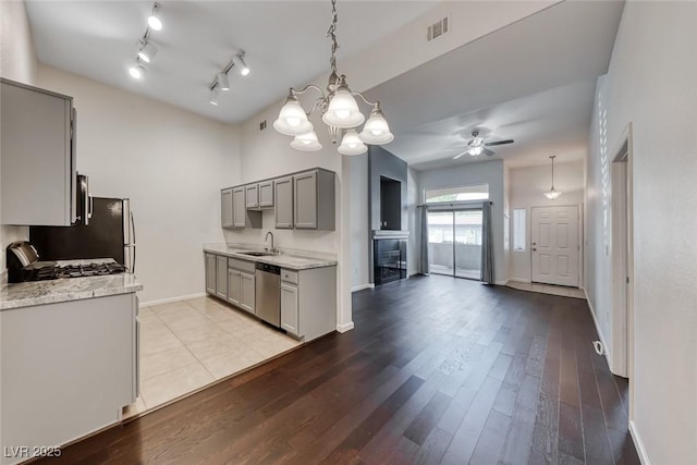 8805 Jeffreys St Unit 1048, Las Vegas, NV 89123 - kitchen with gray cabinetry, stainless steel dishwasher, ceiling fan, a chandelier, and light wood-style floors