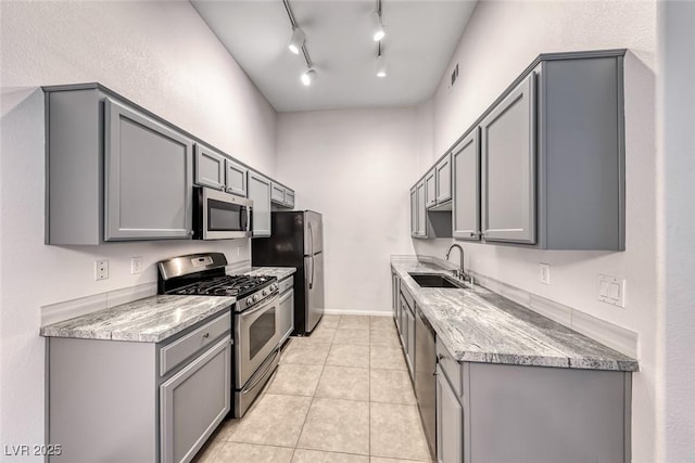 8805 Jeffreys St Unit 1048, Las Vegas, NV 89123 - kitchen featuring stainless steel appliances, gray cabinetry, light tile patterned floors, and light stone countertops