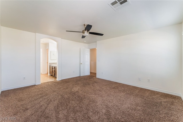 2400 Dutchmans Pipe Ct, Las Vegas, NV 89106 - unfurnished bedroom with light colored carpet, arched walkways, ensuite bathroom, and a ceiling fan