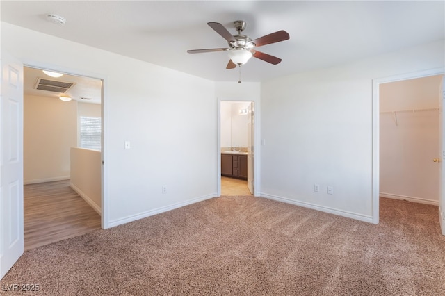 2400 Dutchmans Pipe Ct, Las Vegas, NV 89106 - unfurnished bedroom featuring light carpet, a spacious closet, a ceiling fan, and ensuite bath