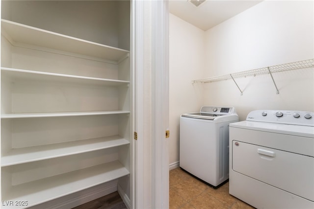 2400 Dutchmans Pipe Ct, Las Vegas, NV 89106 - laundry room with washing machine and dryer and tile patterned flooring