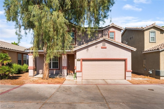 2400 Dutchmans Pipe Ct, Las Vegas, NV 89106 - view of front facade featuring concrete driveway, stucco siding, an attached garage, and a tiled roof