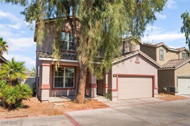 2400 Dutchmans Pipe Ct, Las Vegas, NV 89106 - view of front of house with concrete driveway, stucco siding, an attached garage, and a tile roof
