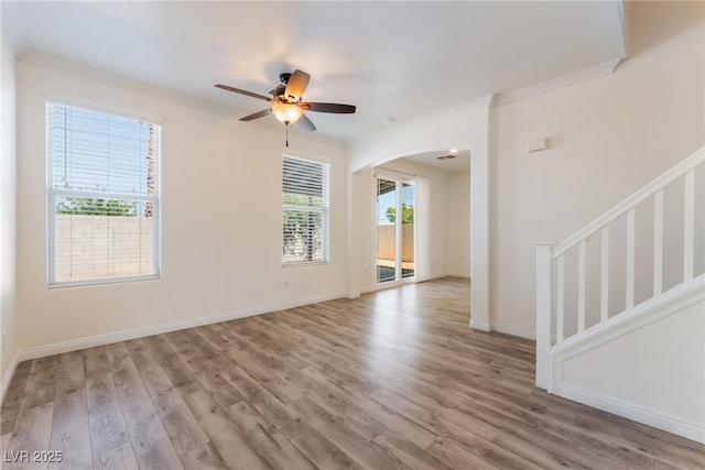 2400 Dutchmans Pipe Ct, Las Vegas, NV 89106 - unfurnished room featuring arched walkways, crown molding, wood finished floors, ceiling fan, and stairway