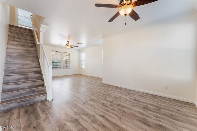 2400 Dutchmans Pipe Ct, Las Vegas, NV 89106 - unfurnished living room with ceiling fan, stairway, and light wood-type flooring