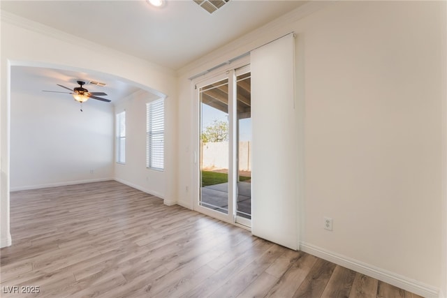 2400 Dutchmans Pipe Ct, Las Vegas, NV 89106 - unfurnished room featuring light wood finished floors, ceiling fan, crown molding, and arched walkways