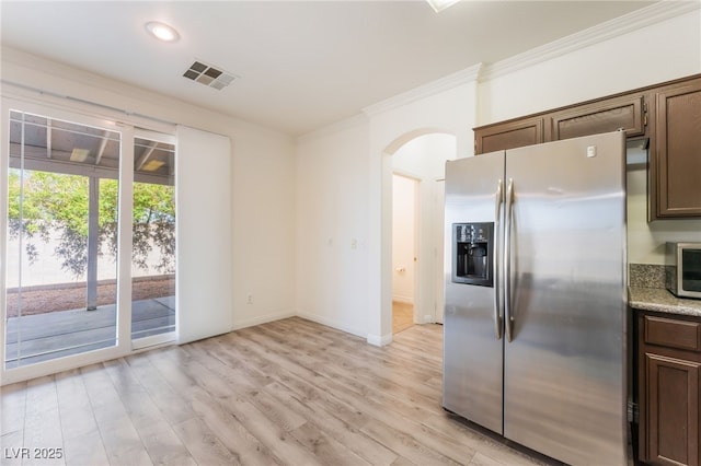 2400 Dutchmans Pipe Ct, Las Vegas, NV 89106 - kitchen featuring stainless steel fridge with ice dispenser, ornamental molding, arched walkways, light wood-style floors, and dark brown cabinets