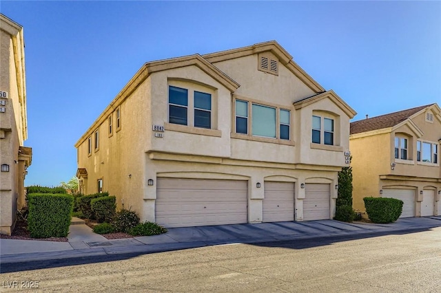 8842 Duncan Barrel Ave Unit 103, Las Vegas, NV 89178 - townhome / multi-family property featuring a garage and stucco siding