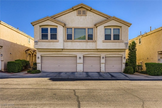 8842 Duncan Barrel Ave Unit 103, Las Vegas, NV 89178 - view of property with stucco siding and a garage