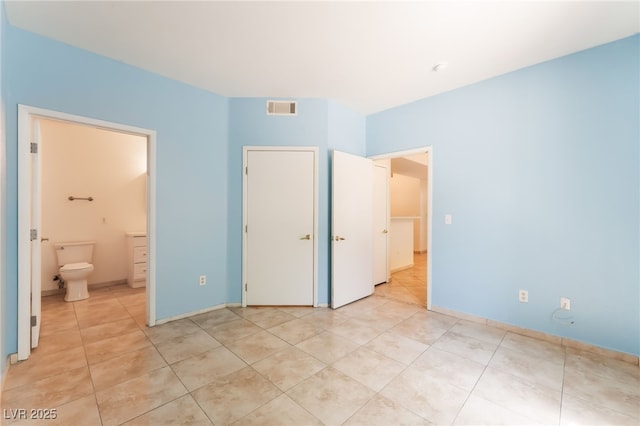 2141 Hussium Hills St Unit 108, Las Vegas, NV 89108 - unfurnished bedroom with light tile patterned flooring and connected bathroom