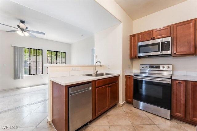 2141 Hussium Hills St Unit 108, Las Vegas, NV 89108 - kitchen featuring stainless steel appliances, a peninsula, light countertops, light tile patterned floors, and a ceiling fan