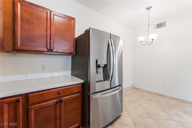 2141 Hussium Hills St Unit 108, Las Vegas, NV 89108 - kitchen with stainless steel fridge with ice dispenser, a chandelier, light countertops, decorative light fixtures, and light tile patterned floors