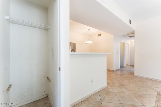 2141 Hussium Hills St Unit 108, Las Vegas, NV 89108 - unfurnished room with a chandelier and light tile patterned flooring