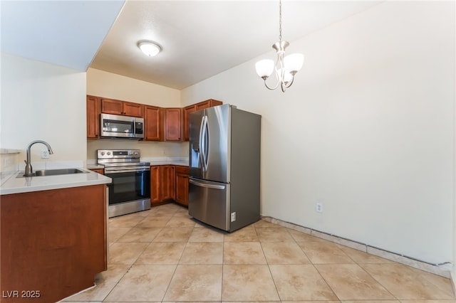 2141 Hussium Hills St Unit 108, Las Vegas, NV 89108 - kitchen featuring appliances with stainless steel finishes, a chandelier, light countertops, pendant lighting, and light tile patterned flooring