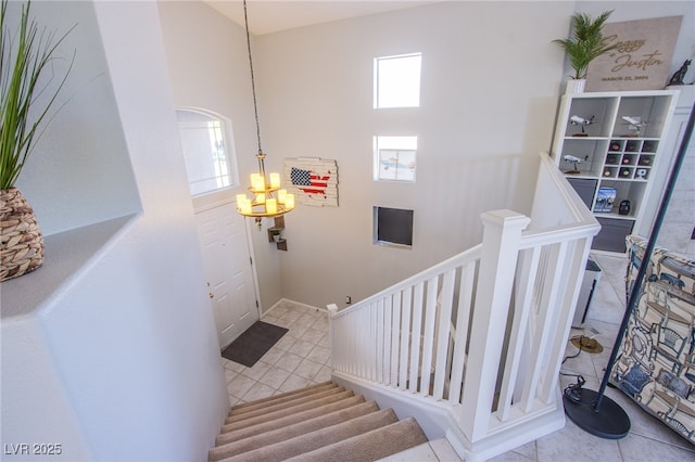 1844 Ghost Trace Ave, Las Vegas, NV 89183 - stairs featuring tile patterned floors, a chandelier, and a high ceiling