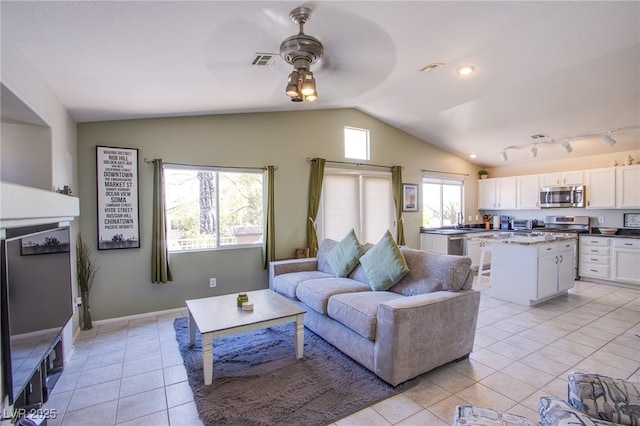 1844 Ghost Trace Ave, Las Vegas, NV 89183 - living room with vaulted ceiling, ceiling fan, light tile patterned floors, and track lighting