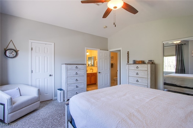 1844 Ghost Trace Ave, Las Vegas, NV 89183 - bedroom featuring lofted ceiling, ensuite bathroom, light colored carpet, and ceiling fan