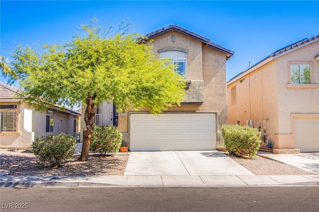 1844 Ghost Trace Ave, Las Vegas, NV 89183 - view of front of house with a garage, driveway, and stucco siding
