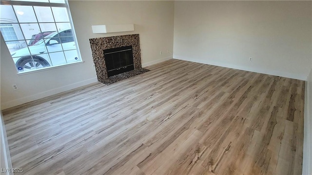 3930 Starfield Ln, Las Vegas, NV 89147 - unfurnished living room with light wood-type flooring and a high end fireplace