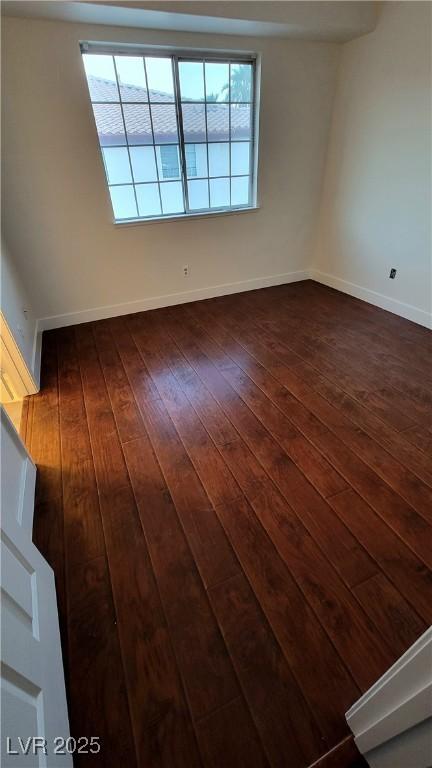 3930 Starfield Ln, Las Vegas, NV 89147 - empty room with dark wood-style floors and baseboards