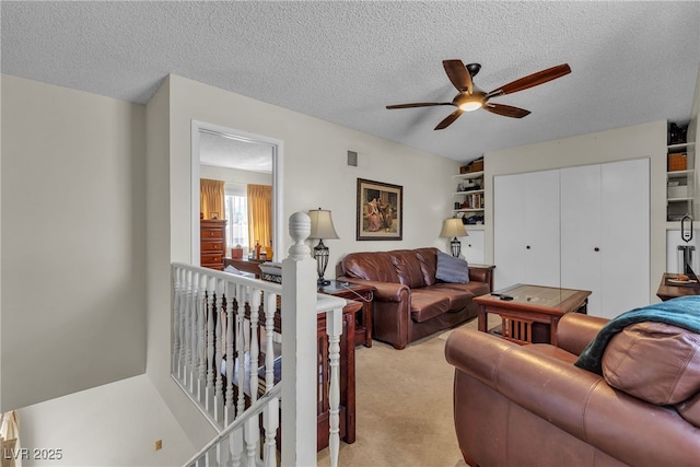909 Biljac St, Las Vegas, NV 89145 - living room with ceiling fan, a textured ceiling, and light colored carpet