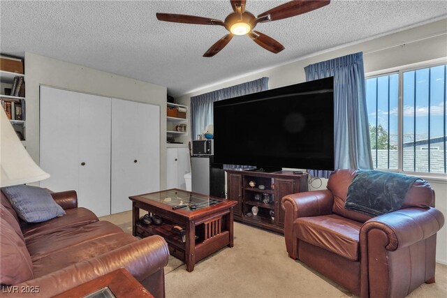 909 Biljac St, Las Vegas, NV 89145 - living room with ceiling fan, light carpet, and a textured ceiling