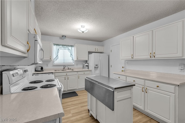 909 Biljac St, Las Vegas, NV 89145 - kitchen featuring white appliances, white cabinets, light wood-style flooring, a textured ceiling, and a center island