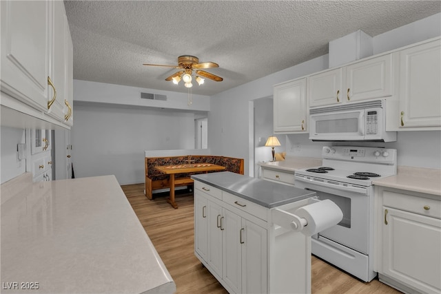 909 Biljac St, Las Vegas, NV 89145 - kitchen featuring white appliances, a ceiling fan, white cabinets, light wood-type flooring, and a textured ceiling