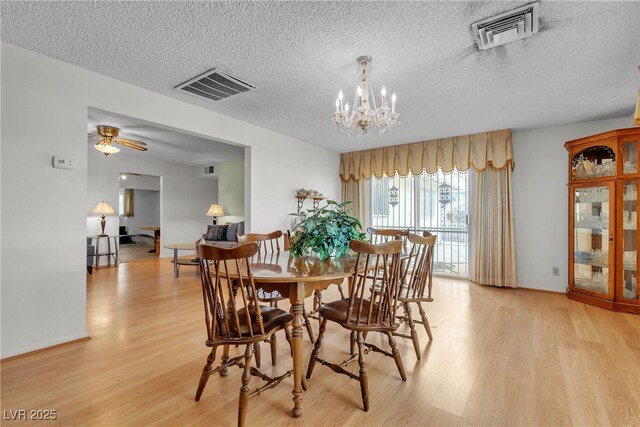 909 Biljac St, Las Vegas, NV 89145 - dining area with light wood finished floors, a textured ceiling, a chandelier, and ceiling fan