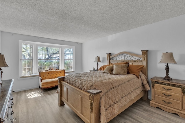 909 Biljac St, Las Vegas, NV 89145 - bedroom featuring a textured ceiling and light wood finished floors
