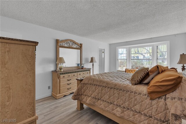 909 Biljac St, Las Vegas, NV 89145 - bedroom with light wood-type flooring and a textured ceiling